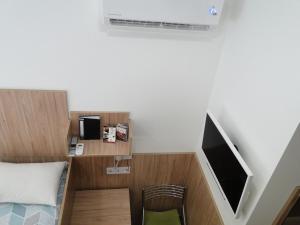 a small room with a bed and a tv at Mini ELEGANT in Kyiv
