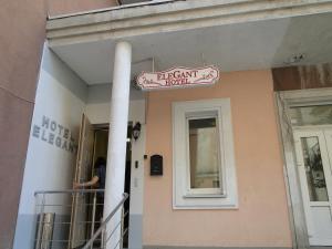 a person standing on the balcony of a building at Mini ELEGANT in Kyiv