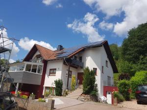 a house with a solar roof on it at Ferienwohnung am Betzelhübel in Ottweiler