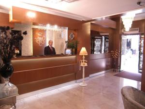 a man standing behind the counter of a bar at Maya Hotel in Istanbul