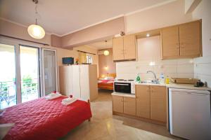 a kitchen with a red bed in a room at Valedina Rooms in Nikiana