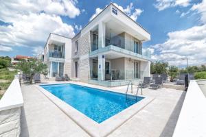 an image of a villa with a swimming pool at Apartments M&L in Vodice