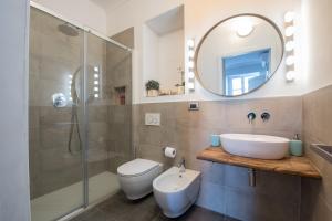 a bathroom with a sink and a toilet and a mirror at Old Town Torino in Turin