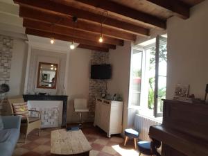 a living room with a couch and a table at Domaine de la belle Lurette in Saint-Pierre-dʼAurillac