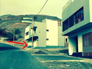 a building on the side of a road next to a building at T1 Família Luz in Mindelo +2 photos