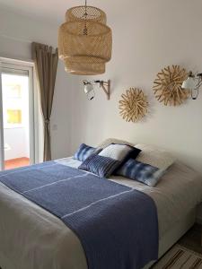 a bedroom with a bed with two pillows on it at Ria Sunset House Alvor in Alvor