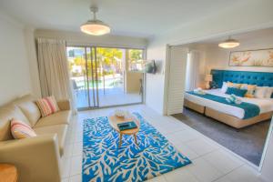 a living room with a bed and a couch at 1770 Lagoons Central Apartment Resort Official in Agnes Water +48 photos