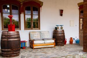 a room with a couch and two large barrels at D. TERESINHA in Vila de Frades