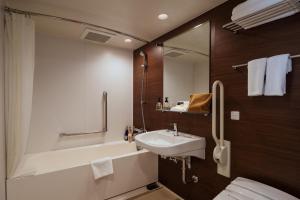 a bathroom with a sink, toilet and bathtub at Hotel Mystays Premier Akasaka in Tokyo