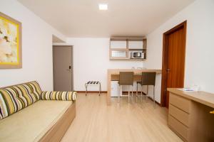 a living room with a couch and a table at Hotel Atlântico in Guarapari
