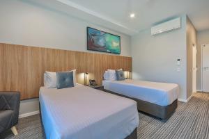 A bed or beds in a room at Best Western Plus North Lakes Hotel