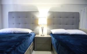 Un pat sau paturi într-o cameră la Hotel Pal Cozumel