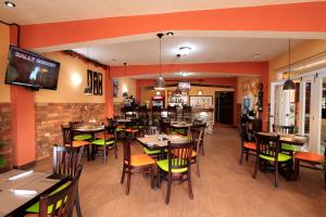 a dining room with tables and chairs in a restaurant at El Delfin Hotel y Restaurante in San Pedro La Laguna