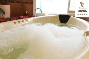 a bath tub filled with water in a sink at Lakeside Cottage Luxury B&B in Mount Dandenong