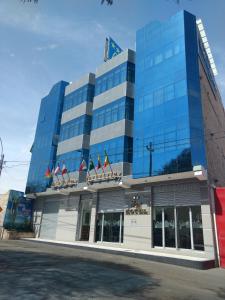 a large glass building with flags on it at Hotel Santa María in Tacna