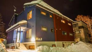 a building in the snow at night at Yuki Yama Apartments in Niseko