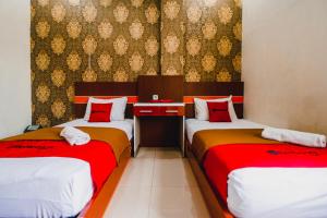 Postel nebo postele na pokoji v ubytování RedDoorz Plus at Grand City Inn Makassar