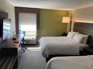 a hotel room with two beds and a television at Holiday Inn Express - Horse Cave, an IHG Hotel in Horse Cave