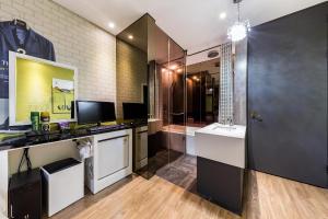 a bathroom with a sink and a desk with a computer at Hotel Cullinan jongno in Seoul