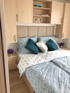 a bedroom with a bed with pillows on it at Marina seahouse Portorož in Lucija