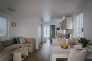 a living room with a couch and a table at Marina seahouse Portorož in Lucija