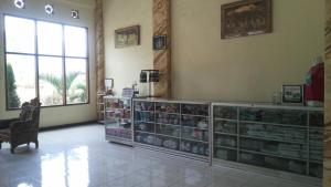 a room with glass shelves and a large window at Hotel Nadia Bromo in Bromo
