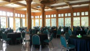 a large room with tables and chairs and windows at Hotel Nadia Bromo in Bromo