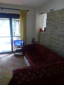 een woonkamer met een bank en een tv bij Sithonia Alekos Luxury Experience in Metamorfosi