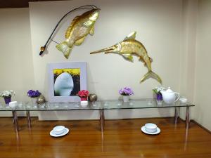a room with a glass table with dolphins on the wall at Lifos Hotel in Kayseri