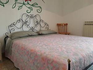 a bedroom with a bed with a metal head board at Villino Carolina in Porto Cesareo