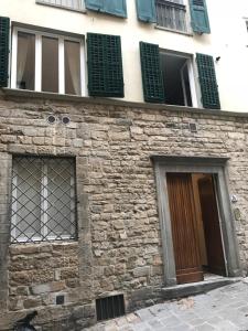 an old stone building with windows and a door at Angeli in Costa San Giorgio in Florence