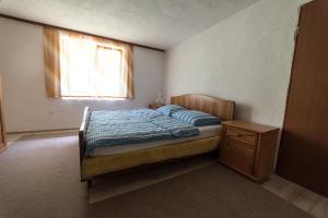 a small bedroom with a bed and a window at Eko House Dobrenica in Bihać