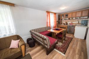 a living room with a couch and a table at Eko House Dobrenica in Bihać