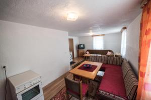 a living room with a couch and a table at Eko House Dobrenica in Bihać