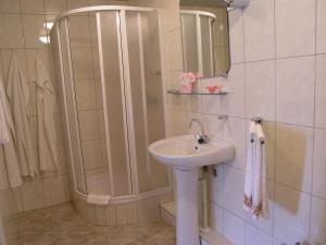 a bathroom with a shower and a sink at Egliu Slenis in Juodkrantė +71 photos