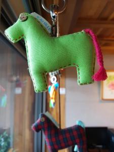 a green toy horse hanging from a ceiling at Jeju Eco Suites in Seogwipo