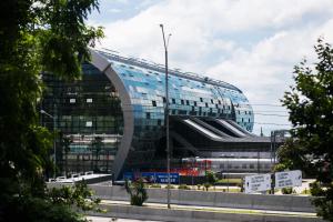 a large glass building with a curved roof at Station in Adler