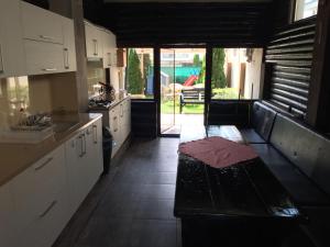a kitchen with a table in the middle of it at Vila Albertino in Eforie Nord