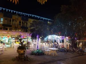 un gruppo di tavoli e sedie con luci notturne di Silverview Resort Holiday a Hong Kong