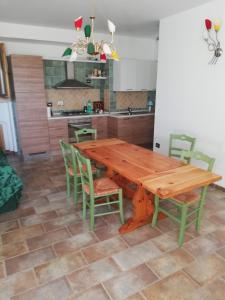 a kitchen with a wooden table and chairs at Il Rifugio Della Luna in Castel Ritaldi +19 photos
