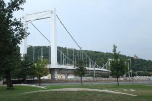 a large white bridge in the middle of a park at Riverside Suite in Budapest