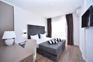 a hotel room with a bed and a television at Apartments 110 in Budva in Budva