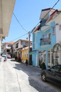 uma rua com um edifício azul e um carro estacionado na rua em ***Vila Toše D. Kruševo em Kruševo