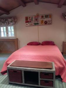 a bedroom with a large bed with a red blanket at Clos de l'Artuby in Valderoure