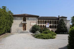 a large stone building with a door and stairs at Casa San Valentino in Bussolengo
