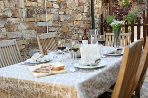 una mesa con comida y copas de vino. en Nature Rural, en Berzosa del Lozoya