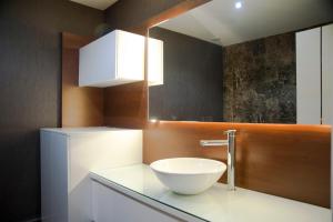 a bathroom with a bowl sink on a counter at Pine City Residence in Kuşadası