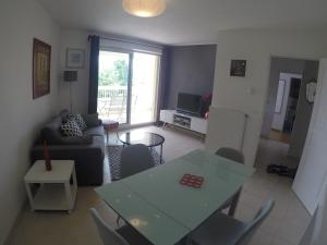 a living room with a table and a couch at Renoir Appartement in Cagnes-sur-Mer