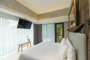 Katil atau katil-katil dalam bilik di ARTOTEL Haniman Ubud