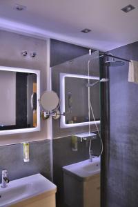 a bathroom with a shower and a sink and a mirror at Hotel-Restaurant Kölbl in Enkenbach-Alsenborn